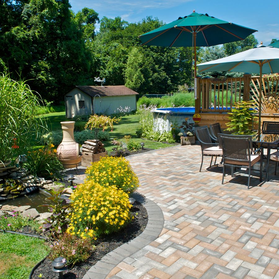 Diving into the heart of our process, we employ a Softwash cleaning technique that effectively and gently eliminates dirt and algae from patios and pavers.